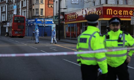 Forensic officers examine the scene of the attack on Streatham High Road, south London.