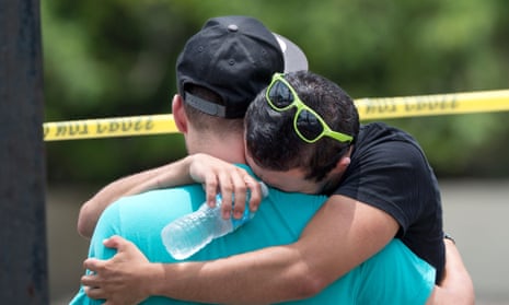 Supported by a friend, a man weeps for victims of the mass shooting just a block from the scene in Orlando, Florida, on June 12, 2016.