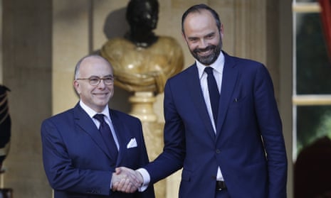 Édouard Philippe, right, is greeted by outgoing prime minister Bernard Cazeneuve in Paris