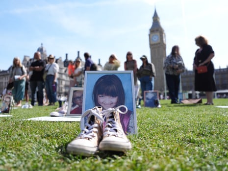 A pair of shoes in front of a photograph of nine-year-old Ellerie Carroll from Bradford, Yorkshire, placed in Parliament Square as part of the Walk In Our Shoes event organised by the It’s Never You.