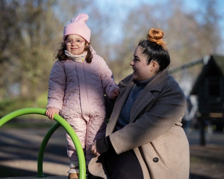 Dafina Bozha and daughter Alessia who is standing on a piece of playground equipment