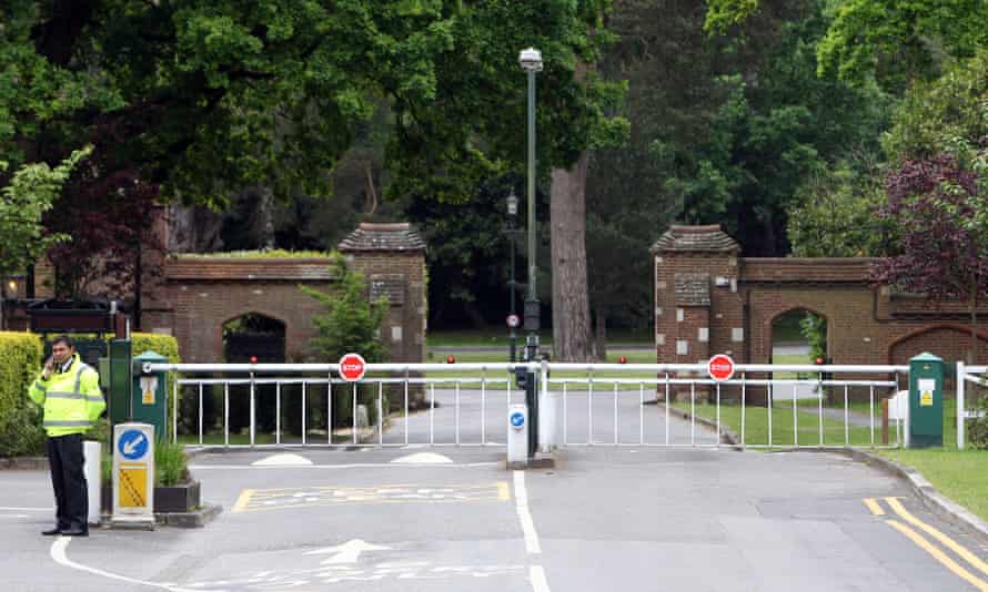 A private security guard outside the 964-acre gated community of St George’s Hill in Surrey.