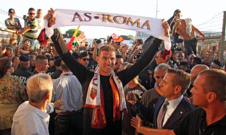 Edin Dzeko is greeted by fans at Rome Fiumicino airport after joining Roma in 2015.