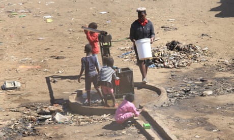 Children play at a borehole in the township of Mbare, Harare, Zimbabwe