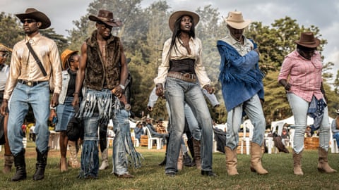 Dancers in cowboy hats and clothes