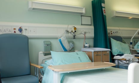 An empty NHS hospital bed on a ward