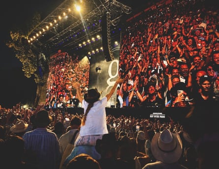Singalong … the crowd join in under the evening lights.