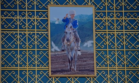 A portrait of president Gurbanguly Berdymukhamedov astride an Akhal-Teke horse welcomes spectators at the main hippodrome entrance.