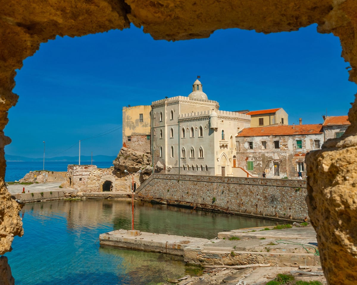 On a blue-sky day, the harbour on Pianosa, Italy, where visitor numbers are strictly limited.
