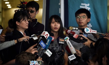 Pro-democracy activists Agnes Chow (C) and Joshua Wong (R) speak to the press after they were released on bail at the Eastern magistrates courts in Hong Kong on 30 August 2019
