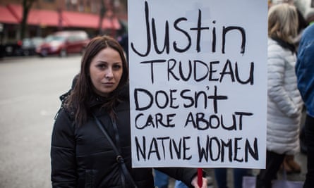 A First Nations woman holds a sign at a 2018 march in Vancouver.