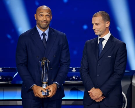 Thierry Henry receives the Uefa President's Award from Uefa president Aleksander Ceferin before the draw.