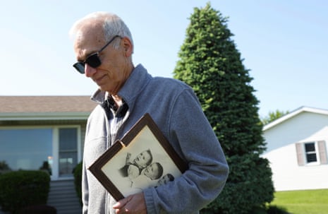 John Prevost, brother of new Pope Leo XIV, holds a portrait of the three Prevost brothers from 1958 while answering reporters' questions outside his home in New Lenox, Illinios.