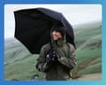 Pete stands on a windy hilltop with a black Davek Elite umbrella