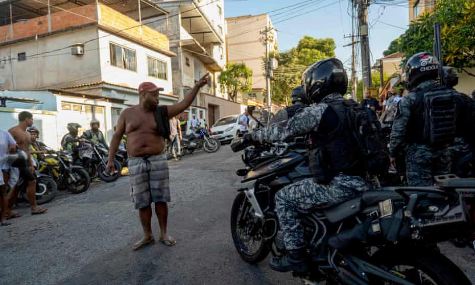 A man shouts at policemen outside the Getulio Vargas hospital, after a police operation  in the Vila Cruzeiro favela left 21 dead.