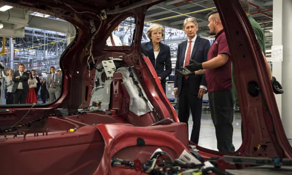 Hammond and Theresa May visiting the Jaguar Land Rover factory in Solihull last year.