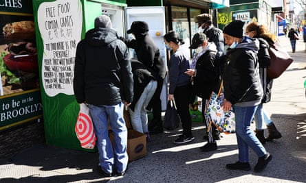 People pick up food from the a mutual aid group’s refrigerator in the Fort Greene neighborhood of Brooklyn.