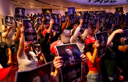 Attendees at an ‘American Comeback’ tour event at the University of Minnesota on 22 September hold up posters of murdered Charlie Kirk.