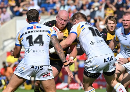 York's Jordan Thompson is tackled by Leeds' Chris Hankinson and Tom Holmes.