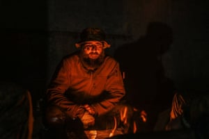 An injured Ukrainian service member sits at a field hospital inside a bunker of the Azovstal Iron and Steel Works
