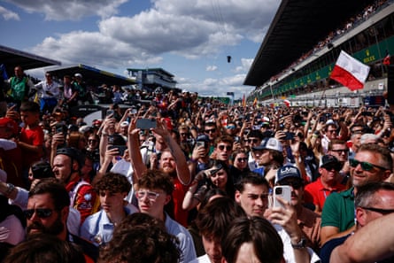 Spectators enjoy the podium ceremony after Ferrari clinched a third successive victory at Le Mans.