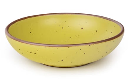 a green bowl with brown speckles