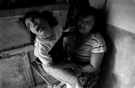 Reyna, 33, with her disabled daughter Cintia, 9, in a Honduras slum
