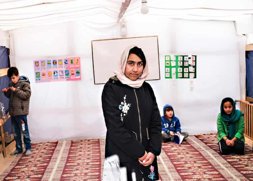 Azita Barekzai, a 19-year-old Afghan English teacher, poses inside a classroom at the school founded by Zekria Farzad