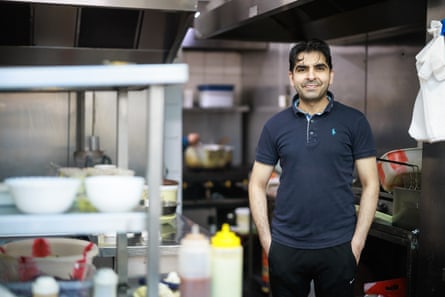 A man standing in the kitchen of a cafe