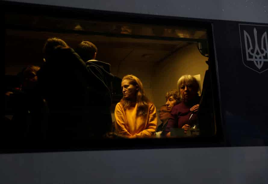 People are seen in an evacuation train from Kyiv to Lviv, at Kyiv central train station.