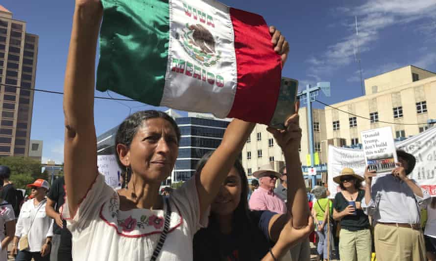 Margarita Perez of Albuquerque, with her daughter by her side, holds up a Mexican flag during a protest on Civic Plaza in Albuquerque, New Mexico, on Saturday, June 30, 2018. Perez was among thousands who gathered on the plaza to voice their opposition to US immigration policies and President Donald Trump.