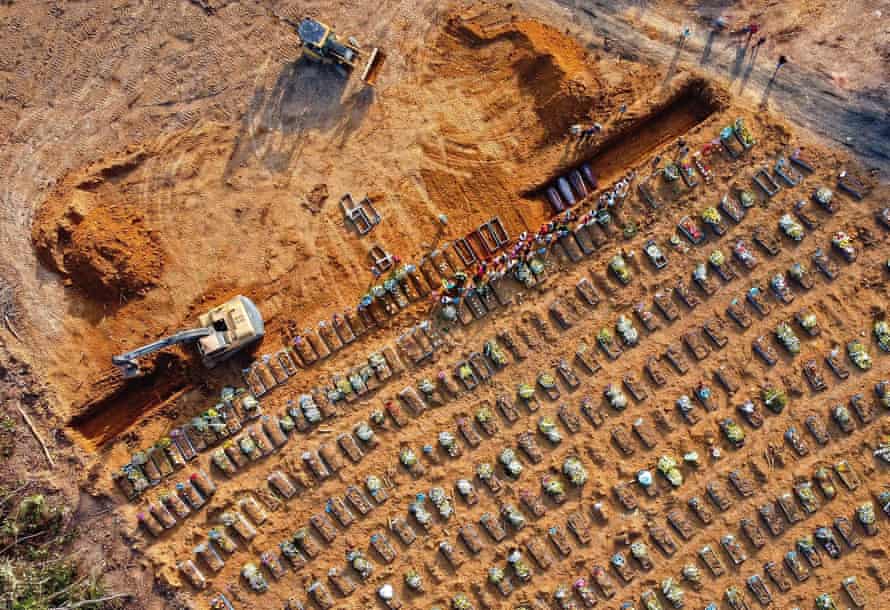 Aerial view of coffins being buried at an area where new graves have been dug at the Parque Tarumã cemetery in Manaus.