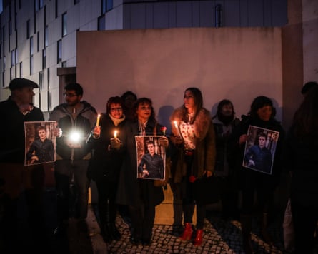 Supporters of the Portuguese football whistleblower Rui Pinto hold a candlelit vigil for him outside of a prison in Lisbon.