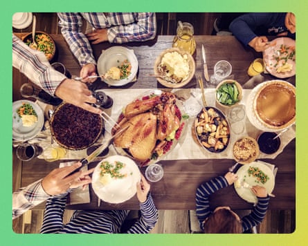 Family having traditional holiday dinner with stuffed turkey, mashed potatoes, cranberry sauce, vegetables pumpkin and pecan pie.