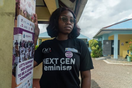Naomi Tulay-Solanke wearing a T-shirt saying Next Gen Feminism, standing outside a building