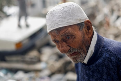 A Palestinian man reacts while looking at houses destroyed in Israeli strikes at Khan Younis refugee camp.