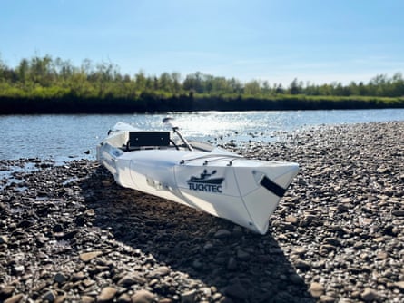 kayak sitting in rocky area beside water