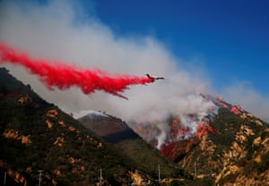 California, US An aircraft drops flame retardant as firefighters battle the Woolsey Fire in Malibu, California