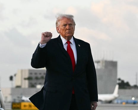 Photograph of Donald Trump signing documents