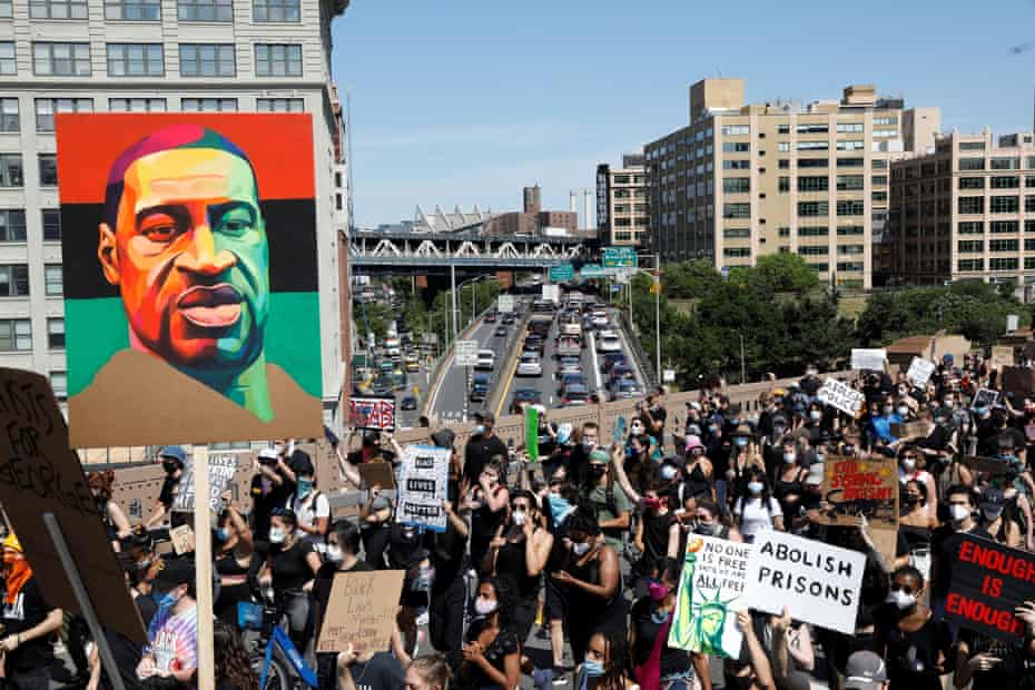 People hold signs as they march during events to mark Juneteenth, which commemorates the end of slavery in Texas, two years after the 1863 Emancipation Proclamation freed slaves elsewhere in the United States, amid nationwide protests against racial inequality, in New York City on 19 June 2020.