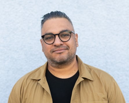 Nikesh Shukla wearing beige shirt over a black T-shirt, against a light background