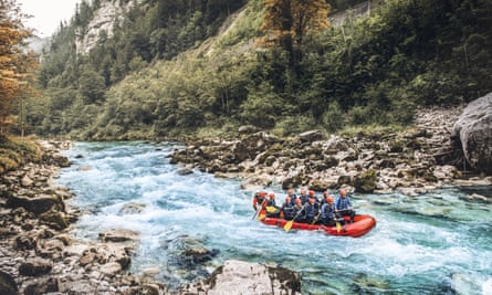 A raft with eight people navigating white water rapids.