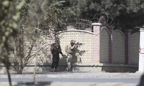Afghan security personnel take a position near the Shamshad TV compound.