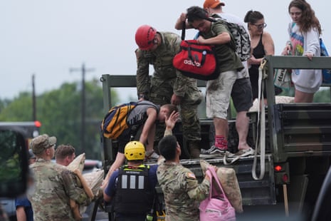 First responders deliver people to a reunification centre after flash flooding in the area, Friday, 4 July 2025, in Ingram, Texas.