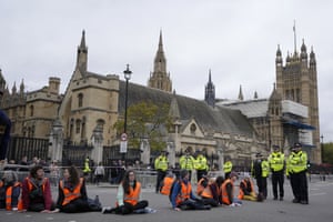 Insulate Britain protestors who have glued their hands to the road.