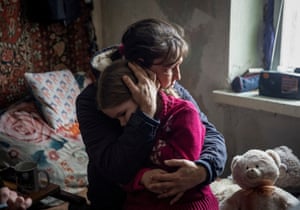 Grandmother Olha hugs her granddaughter Arina, 6, while saying goodbye before her evacuation from the frontline city of Bakhmut