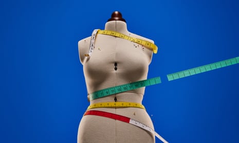A mannequin with tape measures wrapped around it