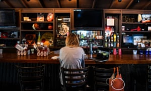 A customer sits at the bar in a restaurant in Atlanta, Georgia, on 27 April.