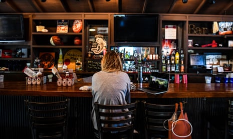 A customer sits at the bar in a restaurant in Atlanta, Georgia, on 27 April. 