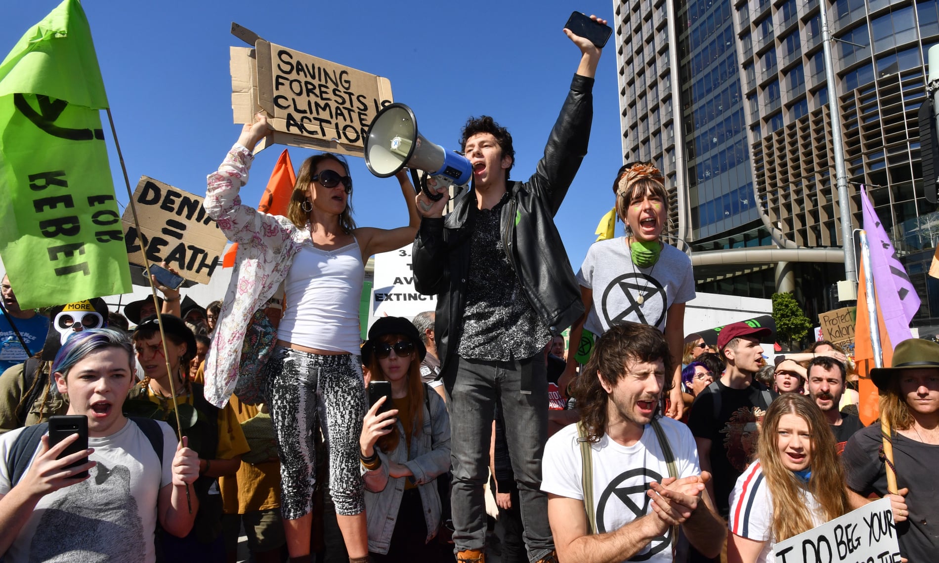 Extinction Rebellion protesters block the corner of Margaret and William streets during a climate change protest in Brisbane